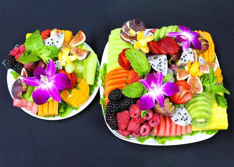 Two plates and fresh cut fruits