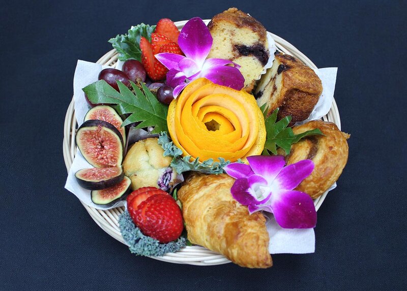 Plate of croissants, strawberries, grapes, figs