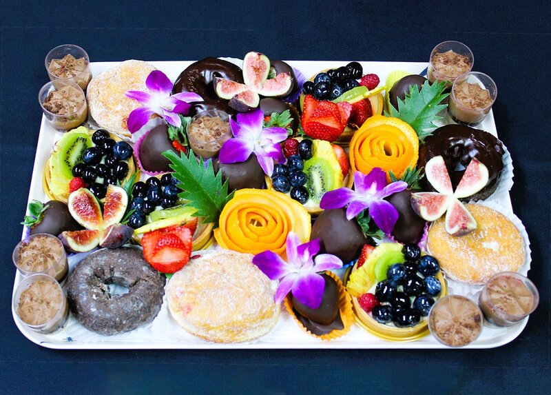 Donuts, chocolate dipped strawberries, yogurt and berries