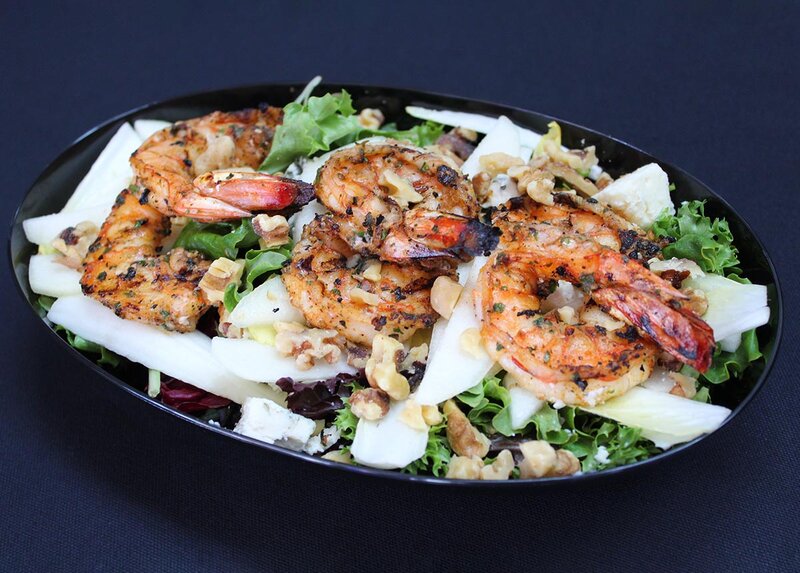 Salad toped with shrimp and cheese