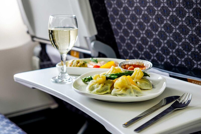 Dumplings with vegetables and a glass of white wine