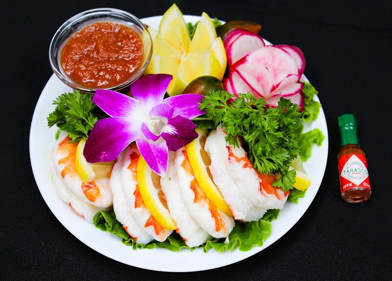 Shrimp with cocktail sauce and lemon wedges