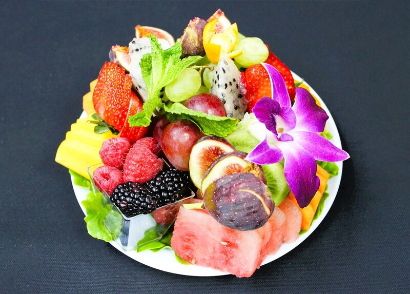 Plate of fresh fruit with berries, watermelon and grapes